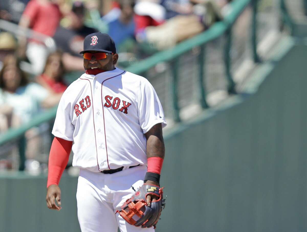 Boston Red Sox third baseman Pablo Sandoval bites on the collar of his shirt during a spring training game against the Tampa Bay Rays on Sunday in Fort Myers, Fla.