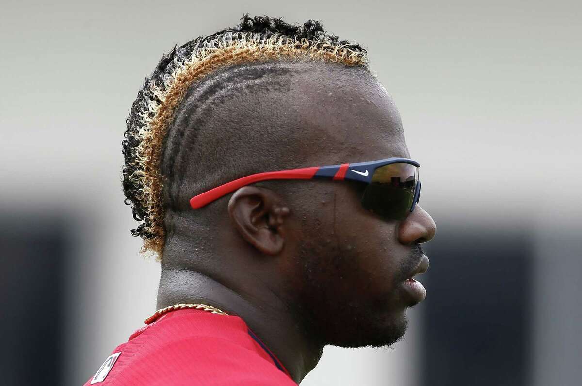 Boston Red Sox's Rusney Castillo sports a golden toned hair style as he runs through conditioning drills at the end of a workout at baseball spring training in Fort Myers Fla., Wednesday Feb. 25, 2015. (AP Photo/Tony Gutierrez)