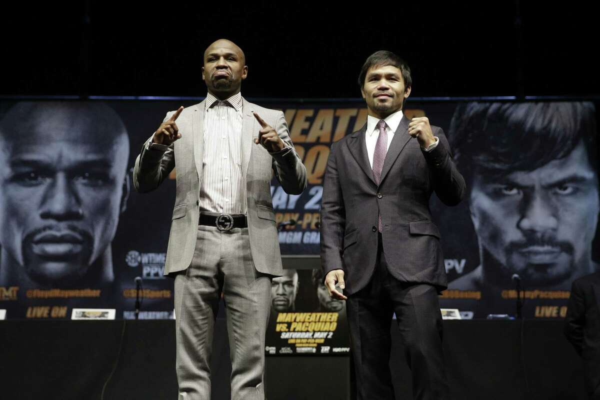 In this March 11 file photo, boxers Floyd Mayweather Jr., left, and Manny Pacquiao pose for photos after a news conference in Los Angeles. The two are scheduled to fight in Las Vegas on May 2.