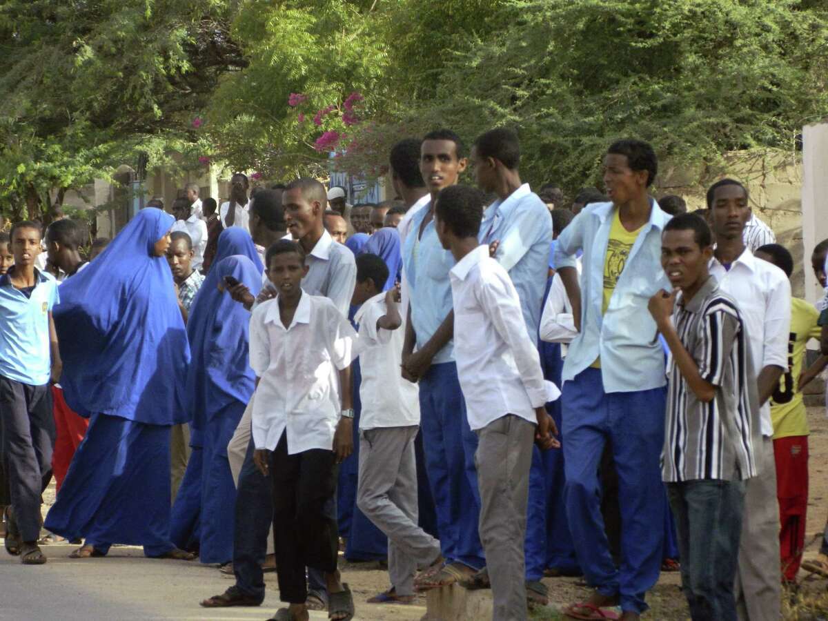 Students gather and watch from a distance outside the Garissa University College after an attack by gunmen, in Garissa, Kenya on April 2, 2015. Gunmen attacked the university early Thursday, shooting indiscriminately in campus hostels.