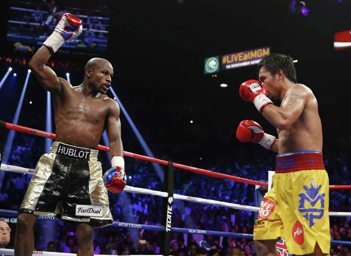 Floyd Mayweather Jr., left, celebrates during his welterweight title fight against Manny Pacquiao on Saturday in Las Vegas.