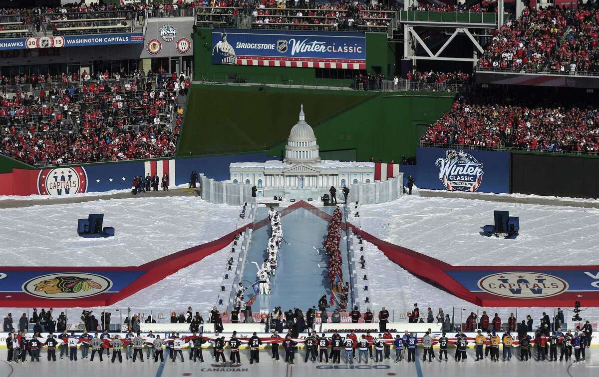 Chicago Blackhawks and Washington Capitals players line up for the national anthem before the start of the Winter Classic on Thursday at Nationals Park in Washington.