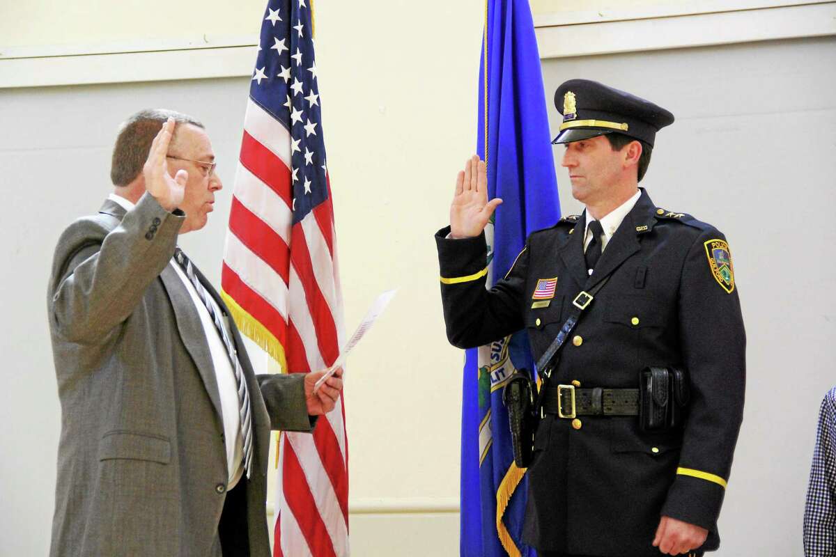 Chairman of the Police Commission Jeffrey Hedberg swears-in Jeffrey Hutchinson as Guilford’s new police chief.