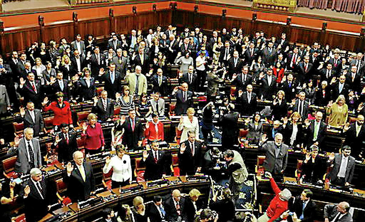 Members of the Connecticut House of Representatives are sworn in at the Capitol in Hartford, Conn., Wednesday, Jan. 9, 2013. Gun control, mental health care and school safety are expected to be major topics in the new session. Legislators also must grapple with a projected deficit of about $1.2 billion.