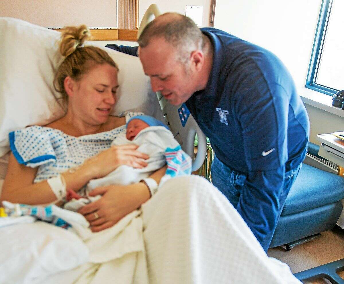 Patrick Smith and Ann Werner, with their son, Declan Richard Smith, Friday in New Haven. Declan was born at born at 12:17 a.m. on New Year’s Day.