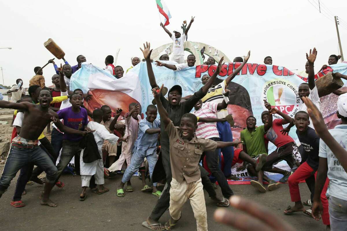 Residents celebrate the anticipated victory of Presidential candidate Muhammadu Buhari in Kaduna, Nigeria Tuesday, March 31, 2015. The spokesman for retired Gen. Muhammadu Buhari says the former military dictator has won Nigeriaís bitterly contested presidential election but fears ìtricksî from the government. Garba Shehu told The Associated Press that their polling agents across the country tell them they have succeeded in defeating President Goodluck Jonathan.(AP Photo/Jerome Delay)