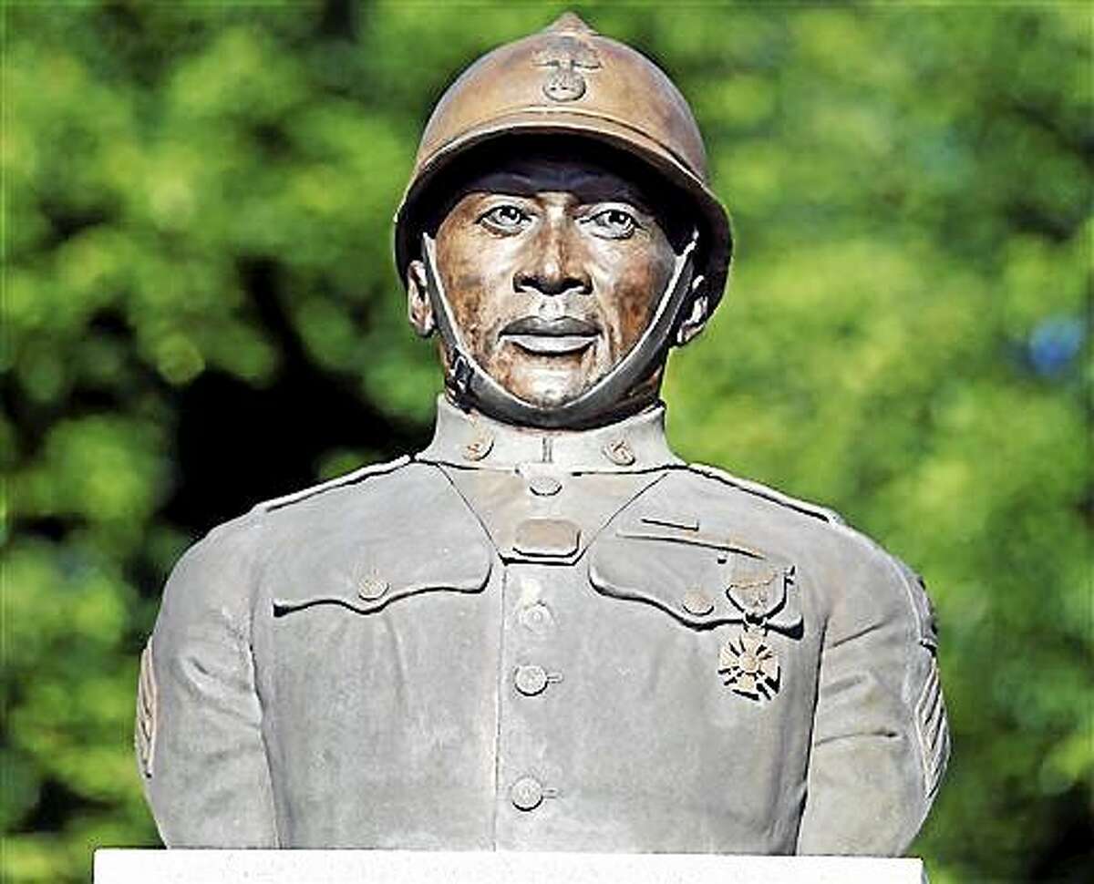 FILE - In this July 10, 2014, file photo, a statue of Henry Johnson is displayed in the Arbor Hill neighborhood in Albany, N.Y. Two World War I Army heroes, Sgt. William Shemin and Johnson are finally getting the Medal of Honor they may have been denied because of discrimination, nearly 100 years after bravely rescuing comrades on the battlefields of France. President Barack Obama plans to posthumously bestow the nation?s highest military honor on both men for their actions in 1918 during a White House ceremony Tuesday, June 2, 2015. (AP Photo/Mike Groll, File)