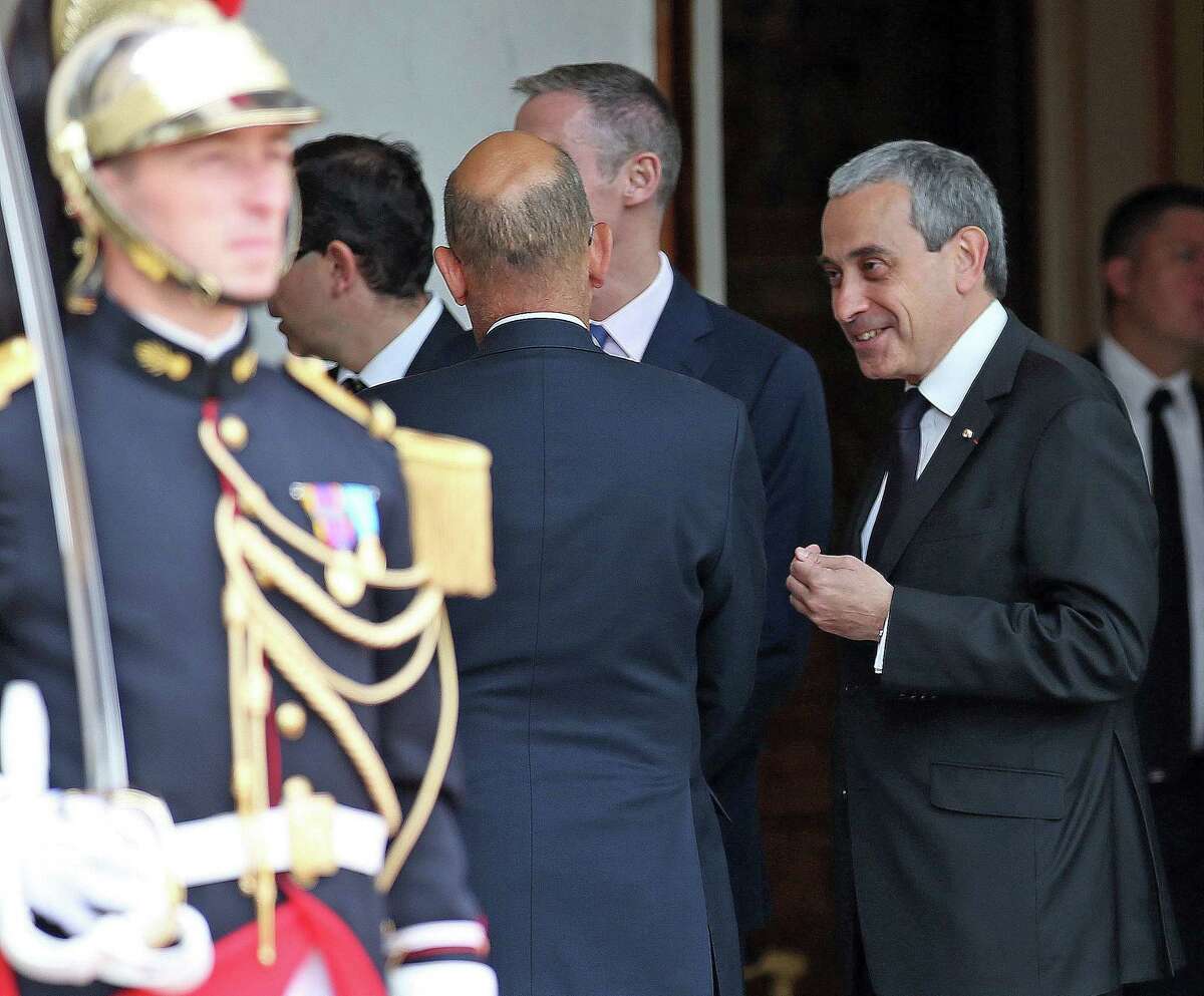 Chief of protocol at the French presidential palace, right, Laurent Stefanini, 54, confers with an unidentified person prior to the arrival of the Spainís King Felipe VI at the Elysee Palace in Paris, France, Tuesday, June 2, 2015. The French government is expecting the Vatican to decide within days whether to approve the nomination of a respected diplomat who is said to be gay as French ambassador to the Holy See. Paris is hoping that Laurent Stefanini wins approval five months after the French presidential palace submitted his nomination. (AP Photo/Remy de la Mauviniere)