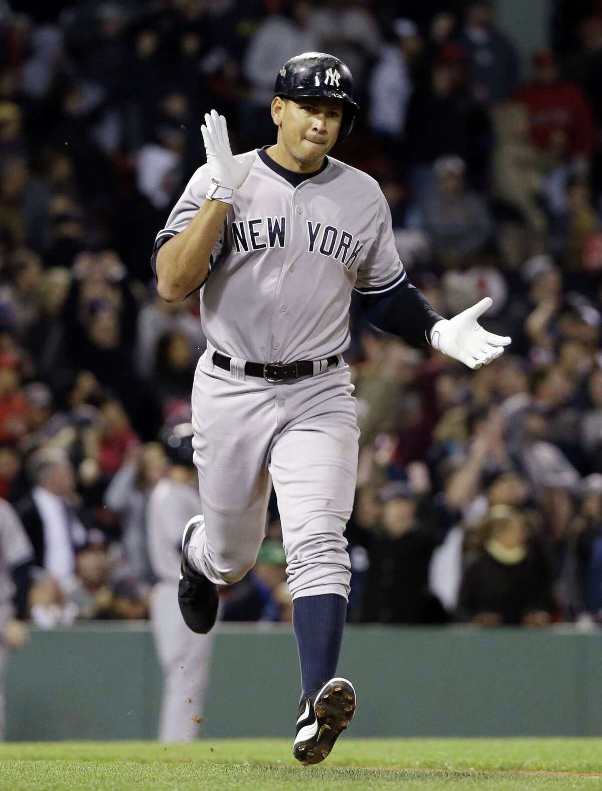 New York Yankees pinch hitter Alex Rodriguez runs to first after hitting a solo homer in the eighth inning of a baseball game against the Boston Red Sox at Fenway Park in Boston, Friday, May 1, 2015. Rodriguez has now tied slugger Willie Mays with 660 career home runs. (AP Photo/Elise Amendola)