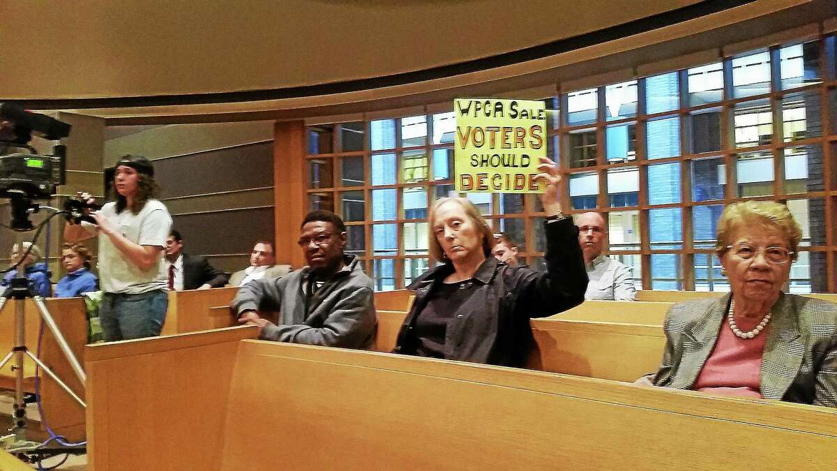 A group of residents opposing a proposal to allow the town of Stratford to join the Greater New Haven Water Pollution Control Authority attends a Board of Alders meeting Monday, including Stratford resident Terry Masters, who brought her own sign.