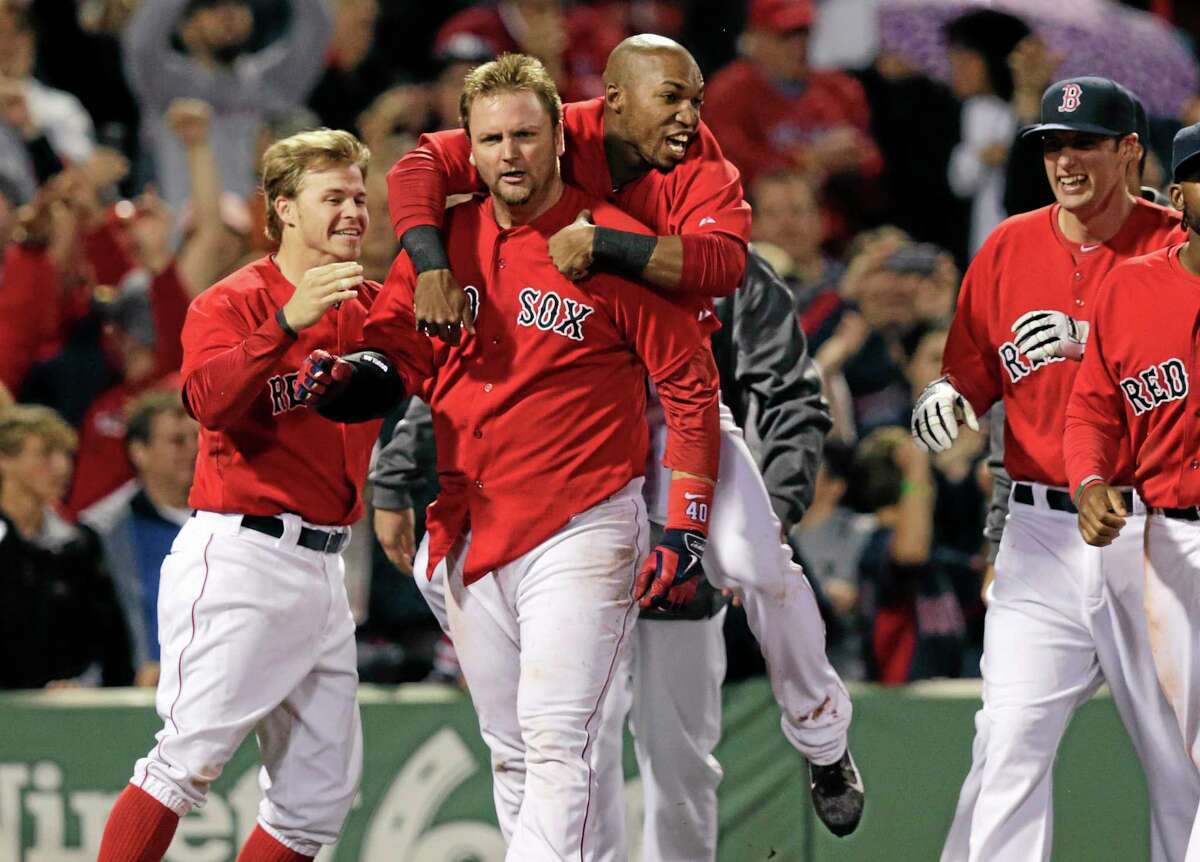 Boston Red Sox’s A.J. Pierzynski is congratulated by teammates after his game-winning RBI triple in the bottom of the 10th inning off Tampa Bay Rays relief pitcher Juan Carlos Oviedo Friday.