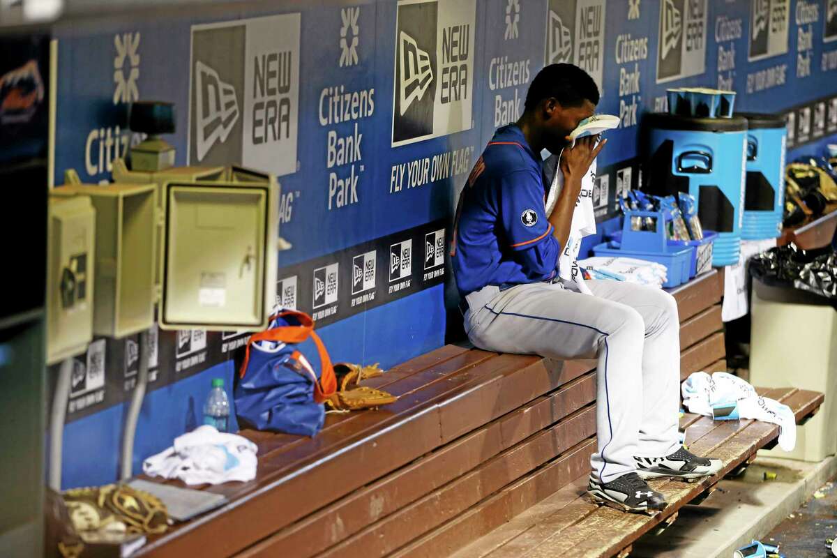 New York Mets starting pitcher Rafael Montero wipes his face on the bench after being pulled in the fourth inning against the Philadelphia Phillies.