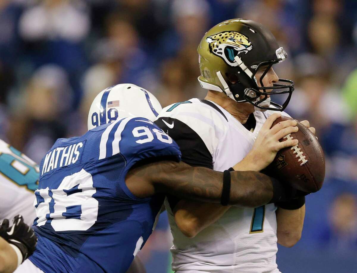 In this Dec. 29, 2013 file photo, Jacksonville Jaguars quarterback Chad Henne (7) is sacked by the Indianapolis Colts’ Robert Mathis (98).