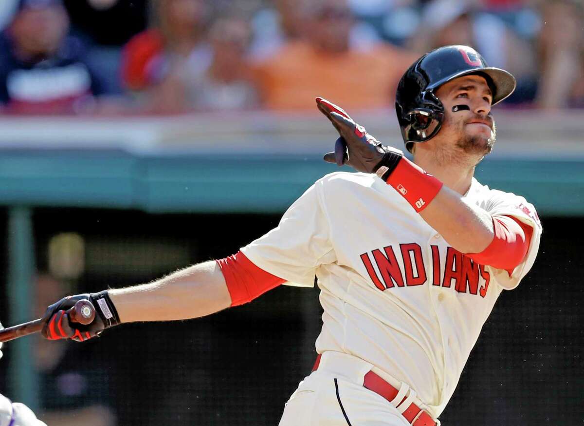 The Indians’ Lonnie Chisenhall watches his two-run home run off Colorado Rockies starter Franklin Morales in the sixth inning of Saturday’s game in Cleveland.