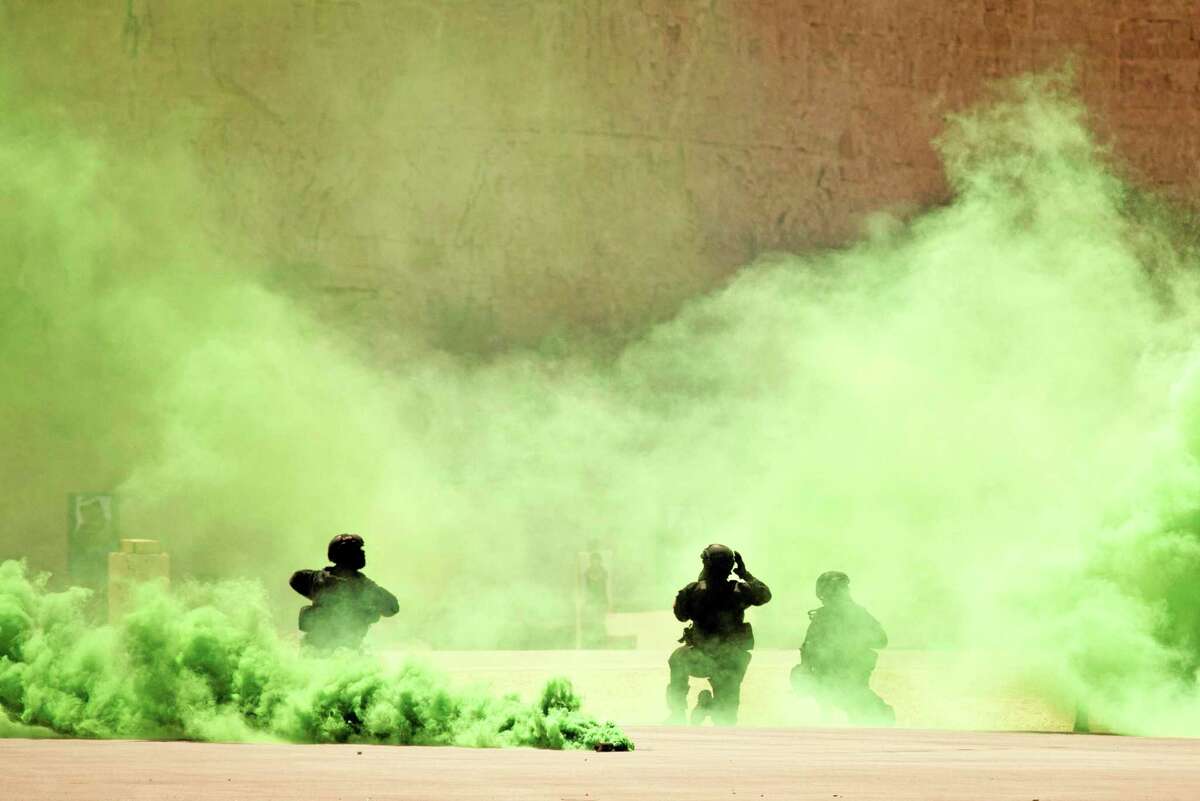 FILE - In this Thursday, June 20, 2013 file photo, soldiers participate in a combined special operations demonstration with commandos from Jordan, Iraq and the U.S. as part of Eager Lion multinational military maneuvers, at the King Abdullah Special Operations Training Center (KASOTC) in Amman, Jordan. The White House soon may sign off on a project to train and equip moderate Syrian rebel forces, according to Obama administration officials. The move would significantly boost U.S. support for rebels seeking military help to oust Syrian President Bashar Assad. President Barack Obama is considering sending a limited number of American troops to Jordan to be part of a regional training mission that would instruct carefully screened members of the Free Syrian Army on tactics, including counterterrorism operations, the officials said.(AP Photo/Maya Alleruzzo, File)
