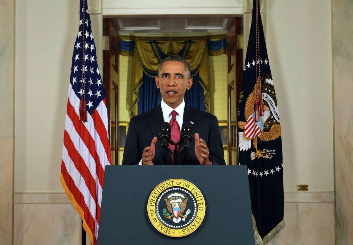 In this AP file photo, President Barack Obama addresses the nation from the Cross Hall in the White House in Washington, Wednesday, Sept. 10, 2014. In a major reversal, Obama ordered the United States into a broad military campaign to ìdegrade and ultimately destroyî militants in two volatile Middle East nations, authorizing airstrikes inside Syria for the first time, as well as an expansion of strikes in Iraq.