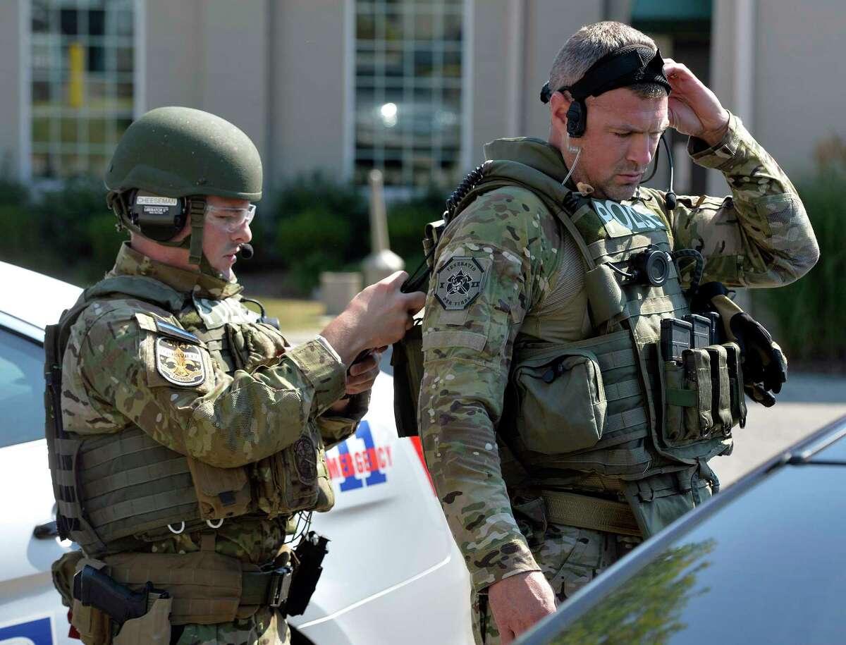 Members of the Louisville SWAT team prepare to enter Fern Creek High School to do a sweep Tuesday, Sept. 30, 2014 at Fern Creek High School in Louisville, Ky. (AP Photo/Timothy D. Easley)