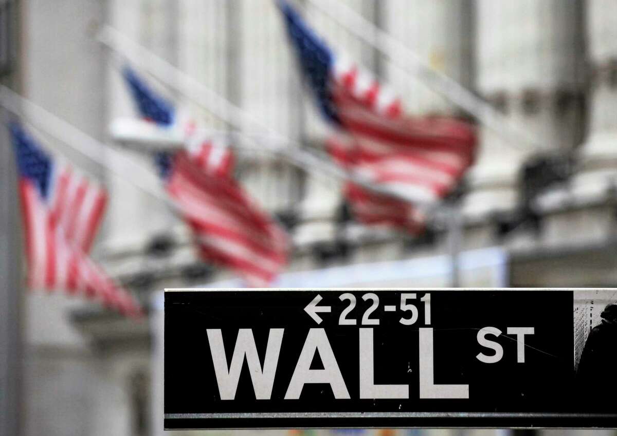 FILE - This April 22, 2010, file photo, shows a Wall Street sign in front of the New York Stock Exchange. U.S. stocks slumped Thursday, July 31, 2014, as investors reacted to disappointing corporate earnings reports and assessed the implications of the approaching end to economic stimulus from the Federal Reserve.