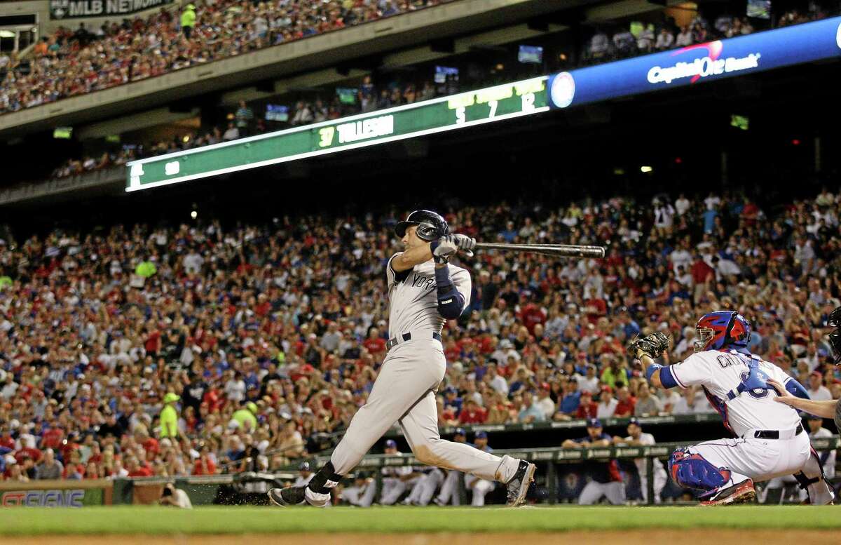 The Yankees’ Derek Jeter hits a single in the sixth inning of Tuesday’s game with the Rangers.
