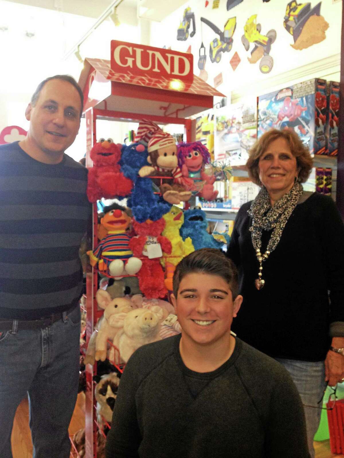Toy Time owner Tom Giaimo, Cole Chase-Beach and Marge Mehlinger in Branford.