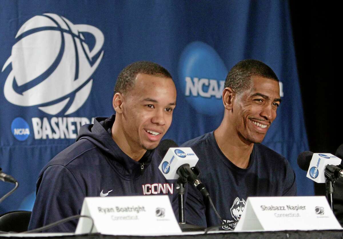 UConn head coach Kevin Ollie, right, reacts as Shabazz Napier responds to a question during a news conference Saturday in New York.