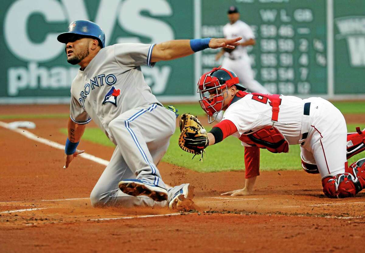 The Blue Jays’ Melky Cabrera slides safely into home past Red Sox catcher Christian Vazquez in the first inning Wednesday.
