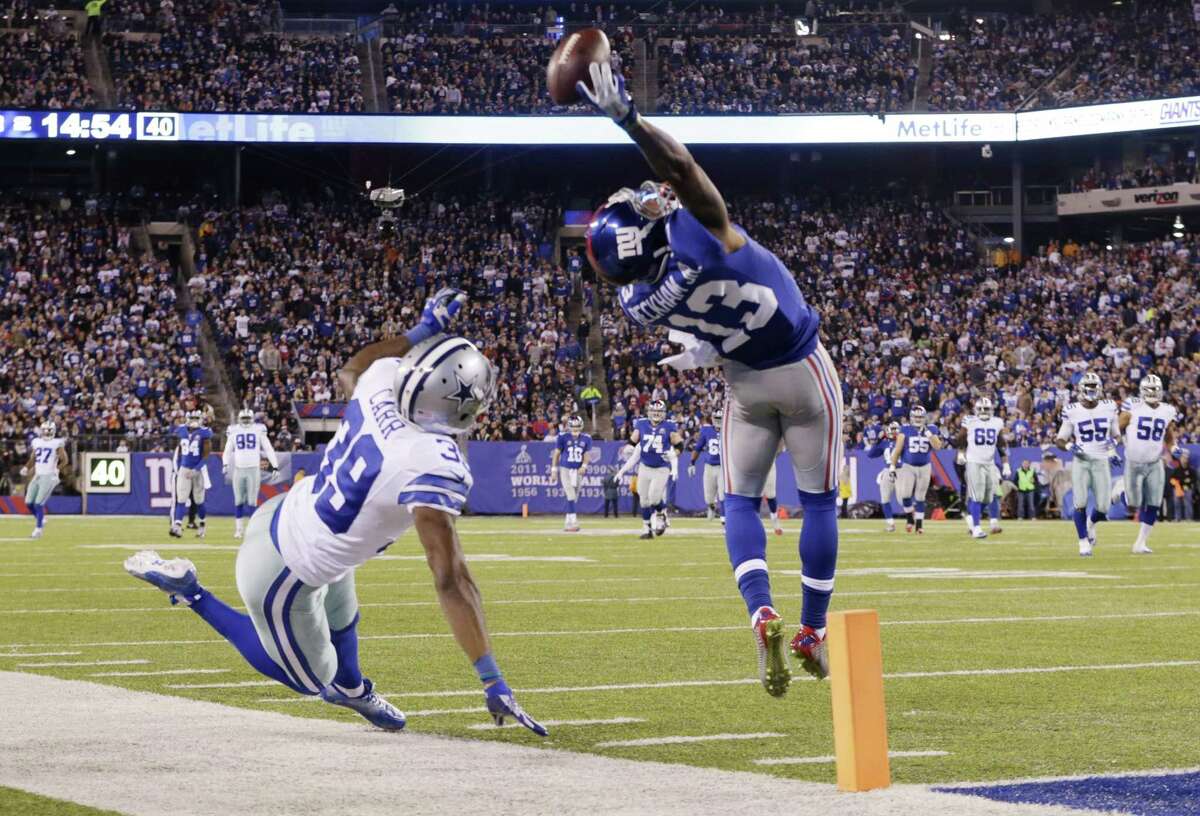 New York Giants receiver Odell Beckham Jr. makes a one-handed catch for a touchdown against Dallas Cowboys cornerback Brandon Carr (39) on Sunday night in East Rutherford, N.J.
