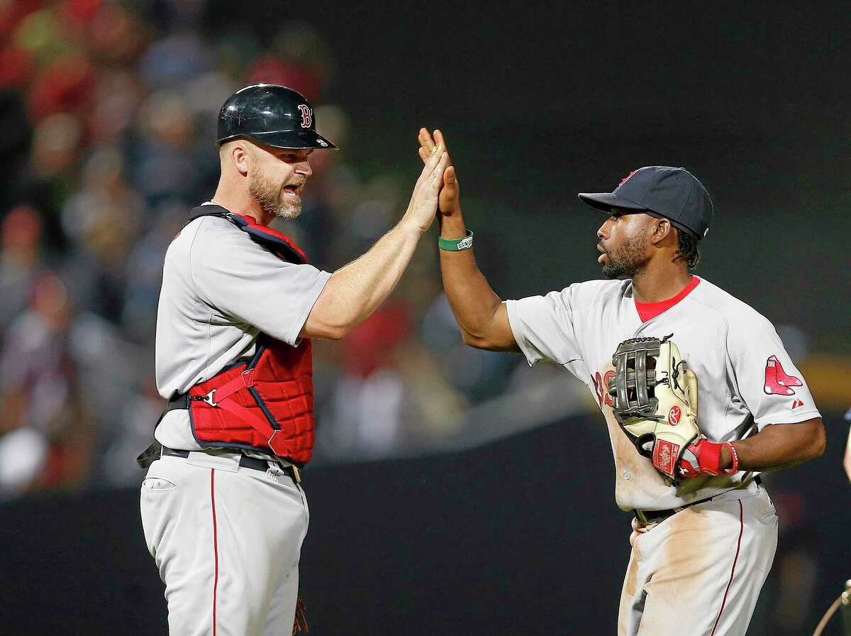 Red Sox center fielder Jackie Bradley Jr., right, and catcher David Ross celebrate after the Red Sox defeated the Atlanta Braves 6-3.