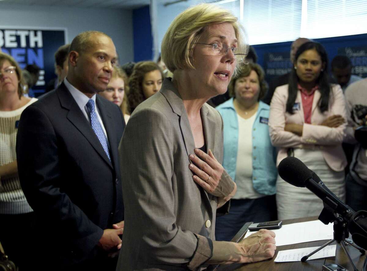 Democratic U.S. Senate candidate Elizabeth Warren, right, takes questions from members of the media as Mass. Gov. Deval Patrick, left, looks on during an event at Warren's campaigns headquarters, in Somerville, Mass., Wednesday, May 30, 2012, during which Patrick formally endorsed Warren in her campaign for the Senate seat. (AP Photo/Steven Senne)