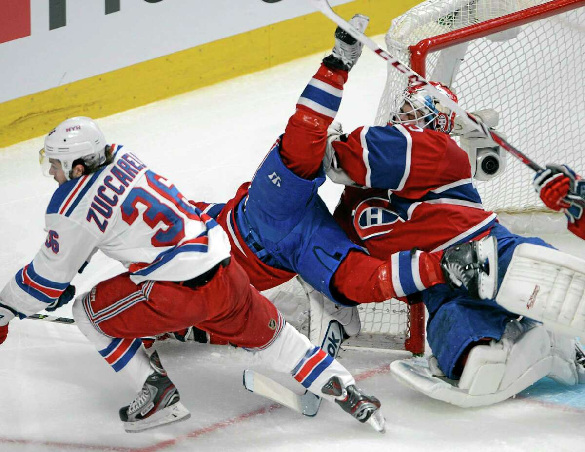 Rangers right wing Mats Zuccarello (36) checks Montreal Canadiens right wing Brian Gionta into Montreal Canadiens goalie Dustin Tokarski during the second period of Game 5 Tuesday.
