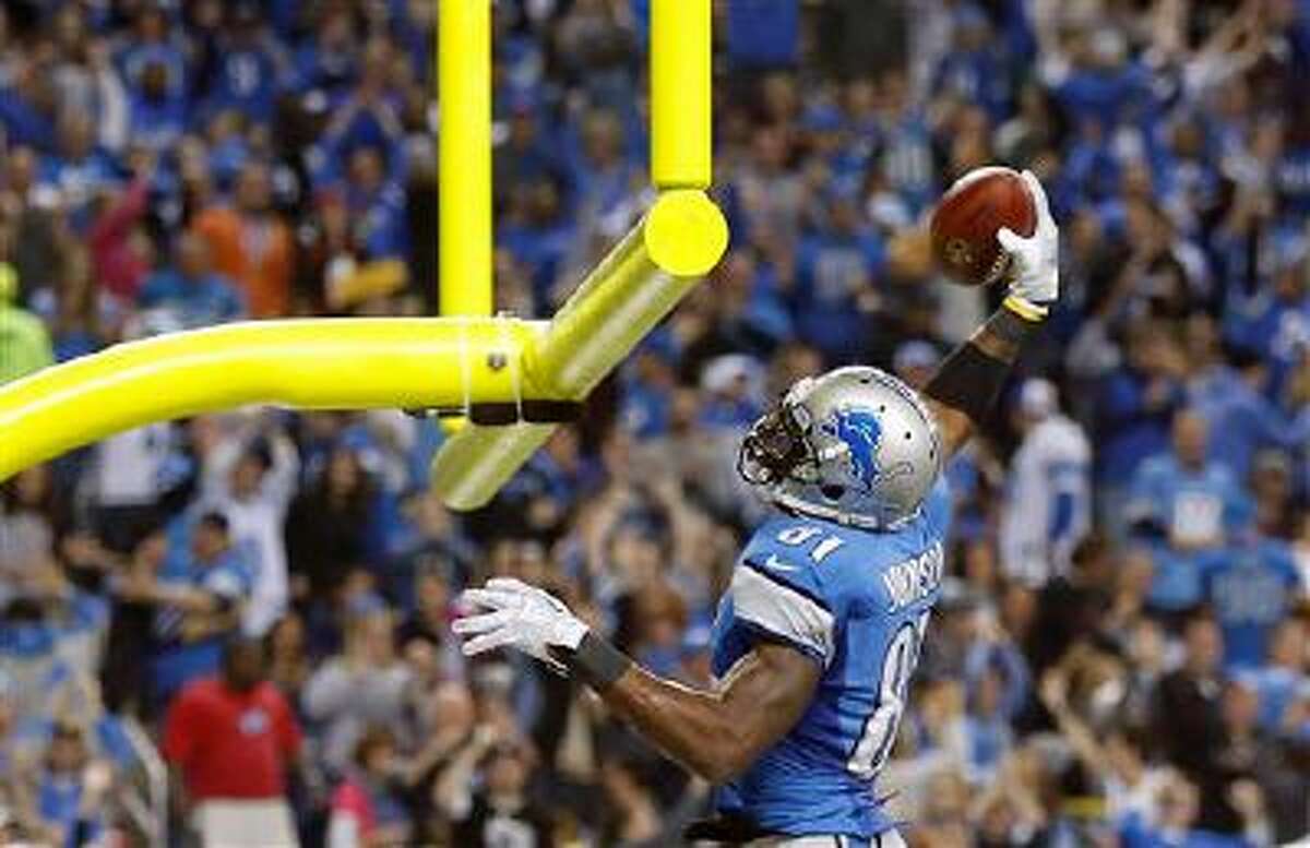 Lions wide receiver Calvin Johnson (81) runs after making the