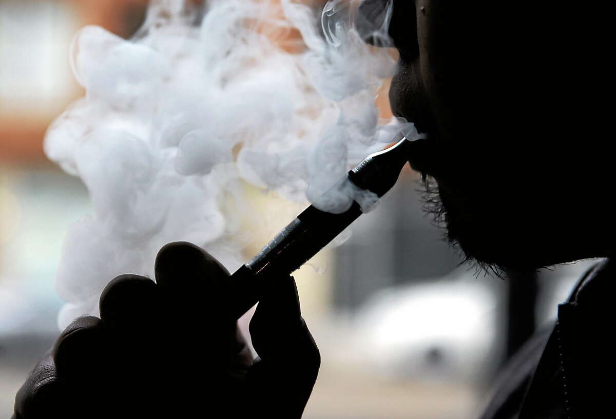 An electronic cigarette is demonstrated in Chicago. Some makers of the liquid nicotine used in electronic cigarettes are using notable brand names like Thin Mint, Tootsie Roll and Cinnamon Toast Crunch to sell their wares.