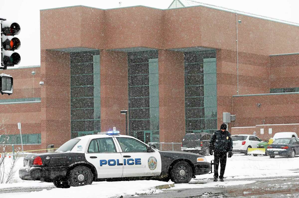 A police cruiser blocks the entrance to Standley Lake HIgh School, where classes were cancelled after an apparent suicide attempt by a student, in Westminster, Colo., Monday, Jan. 27, 2014. Police say a 16-year-old boy was critically injured after setting himself on fire at the suburban Denver high school. (AP Photo/Brennan Linsley)