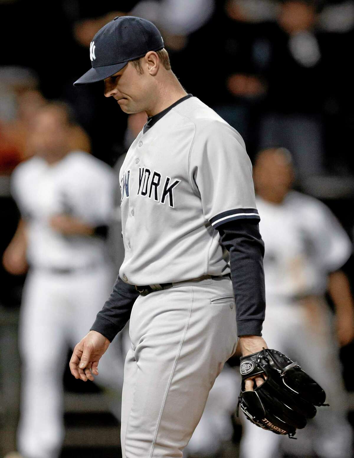Yankees closer David Robertson looks down as he leaves the field after Chicago White Sox’s Adam Dunn hit the game-winning two-run home run during the ninth inning Friday.