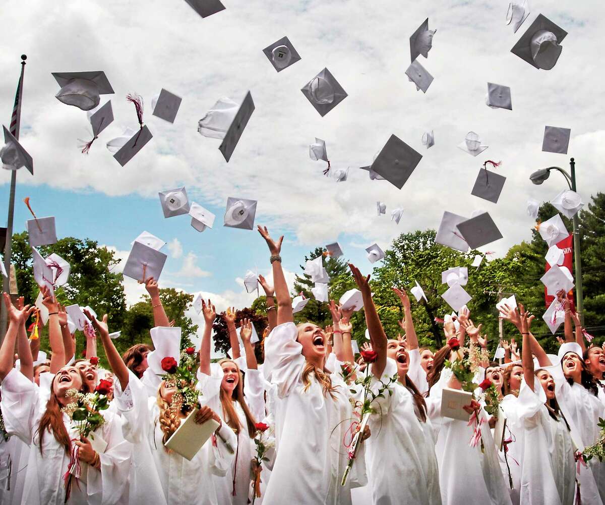 (Melanie Stengel - New Haven Register) Graduates throw their hats into the air after commencement ceremonies at Sacred Heary Academy 5/24.