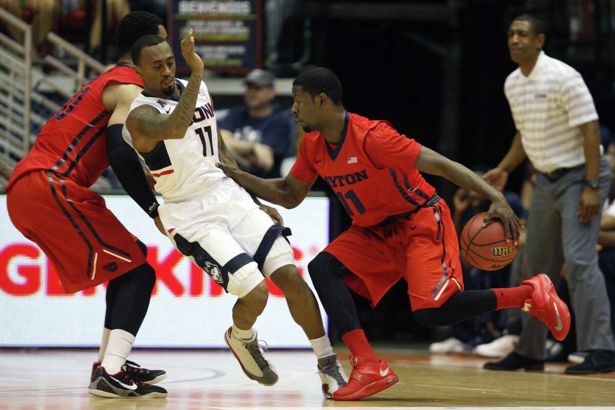 Dayton guard Scoochie Smith, right, dribbles past UConn guard Ryan Boatright during Friday’s game in San Juan, Puerto Rico.