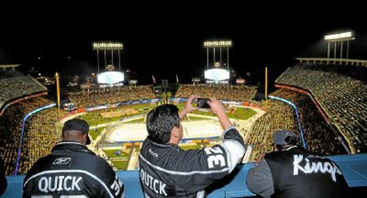 Fans watch the 2014 NHL Stadium Series featuring the Los Angeles Kings taking on the Anaheim Ducks at Dodger Stadium Saturday.