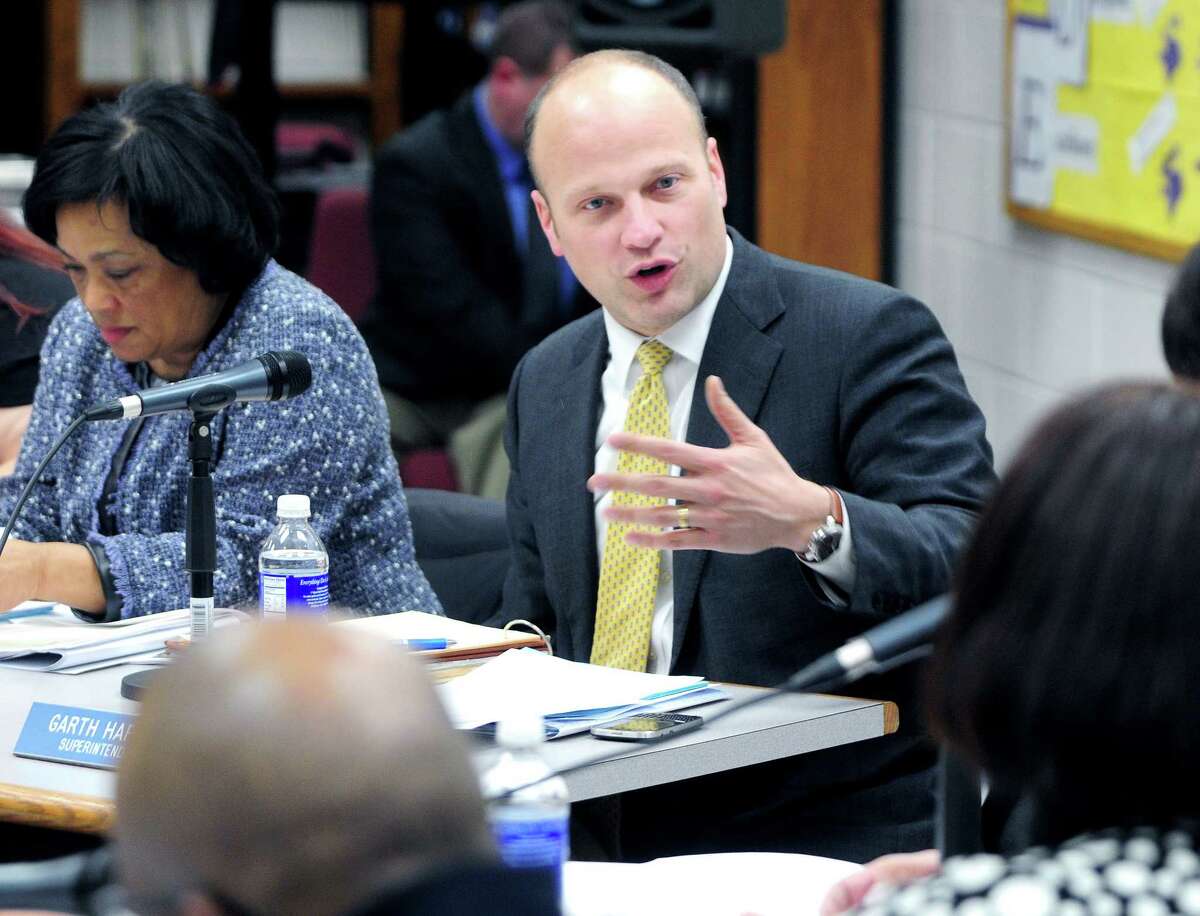 New Haven Superintendent of Schools Garth Harries, center, speaks at a Board of Education meeting at Hill Regional Career High School in February.