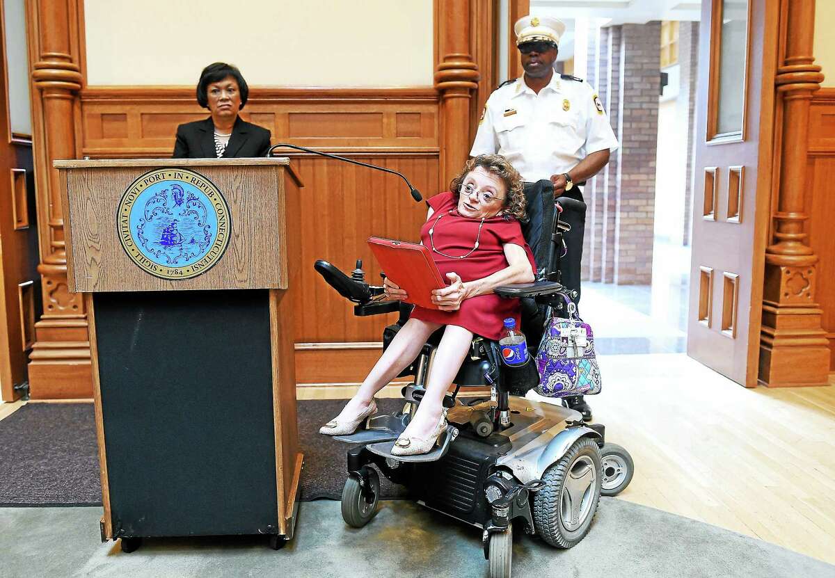 Michelle Duprey, center, director of the Department of Services for Persons with Disabilities of New Haven, speaks at a press conference on the anniversary of the Americans with Disabilities Act at City Hall in New Haven Thursday.