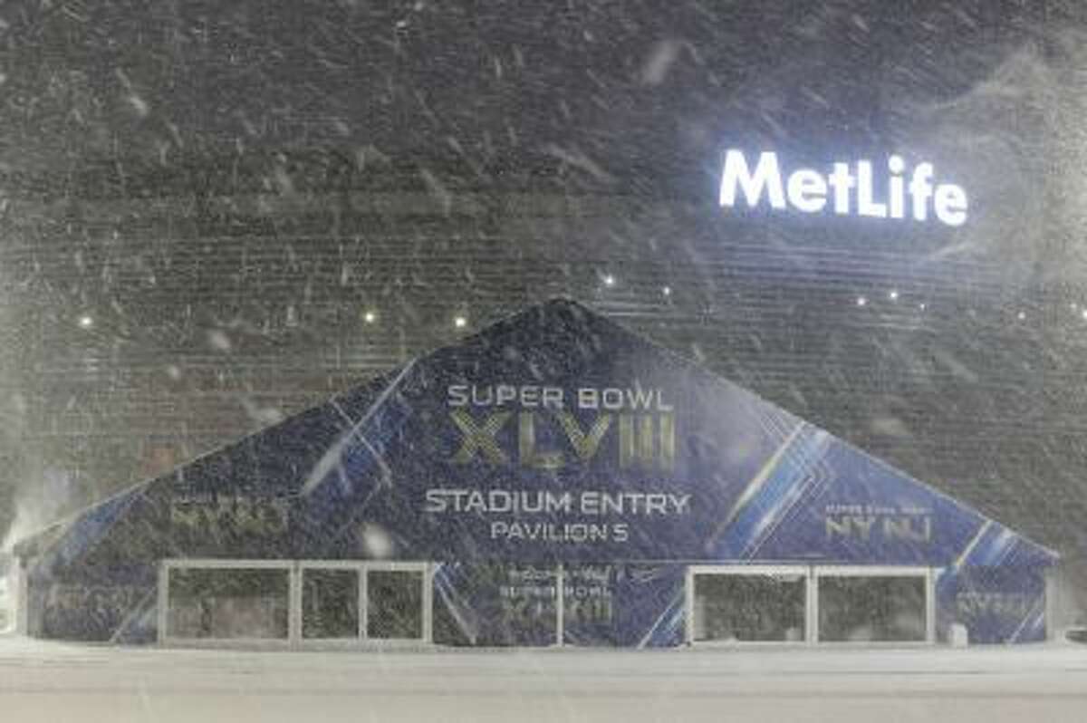 Snow falls over the parking lot of MetLife Stadium in East Rutherford, N.J., where the Super Bowl will be played Feb. 2.