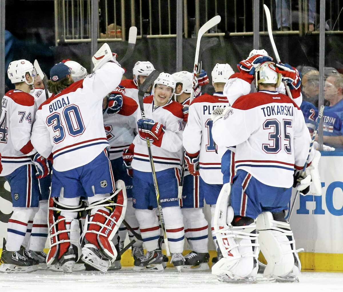 The Montreal Canadiens celebrate after defeating the New York Rangers 3-2 in overtime in Game 3 of the Stanley Cup playoffs Eastern Conference finals.