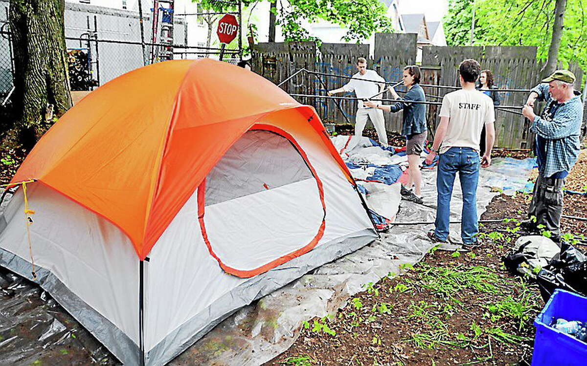 Arnold Gold — New Haven Register file photo Members of Amistad Catholic Worker House set up tents for a Safe Haven on Rosette Street in New Haven in May after overflow shelters closed in the city.