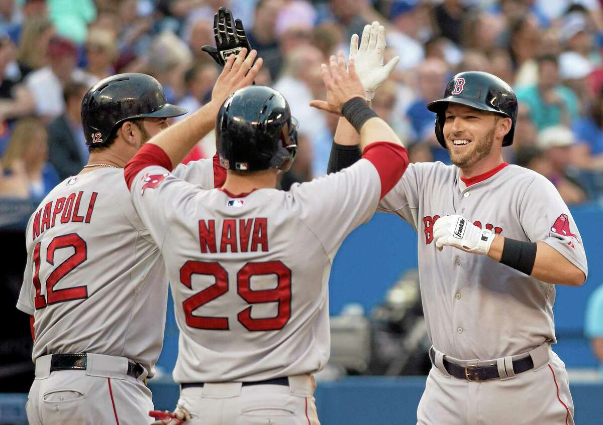 Stephen Drew, right, celebrates his three-run home run with teammates Mike Napoli, left, and Daniel Nava during the third inning Monday.