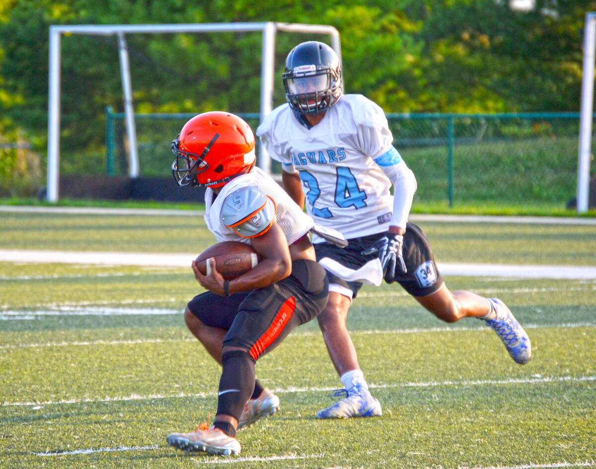 Edwardsville running back Dionte Rodgers eludes a defensive back from Gateway Tech during a 7-on-7 scrimmage on July 17 at the District 7 Sports Complex.