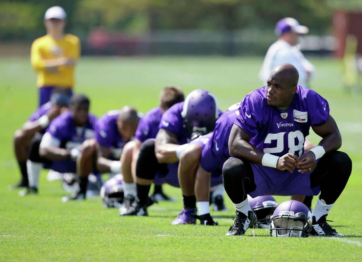 Minnesota Vikings running back Adrian Peterson (28) stretches during training camp in July in Mankato, Minn.