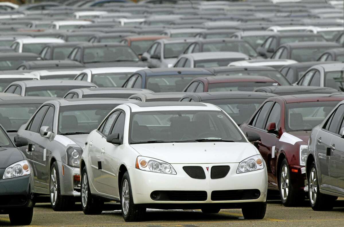 FILE - This March 16, 2006 file photo shows a Pontiac G6 shown outside the General Motors Orion Assembly plant in Orion Township, Mich. General Motors is recalling 2.4 million vehicles in the U.S., including Pontiac G6's from the 2005-2008 model years, as part of a broader effort to resolve outstanding safety issues more quickly. (AP Photo/Paul Sancya, File)