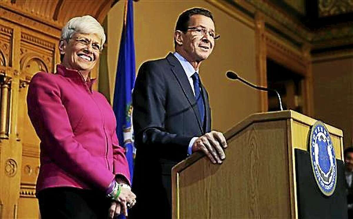 Gov. Dannel Malloy stands with Lt. Gov. Nancy Wyman, left, as they thank supporters Nov. 5 at the State House in Hartford.