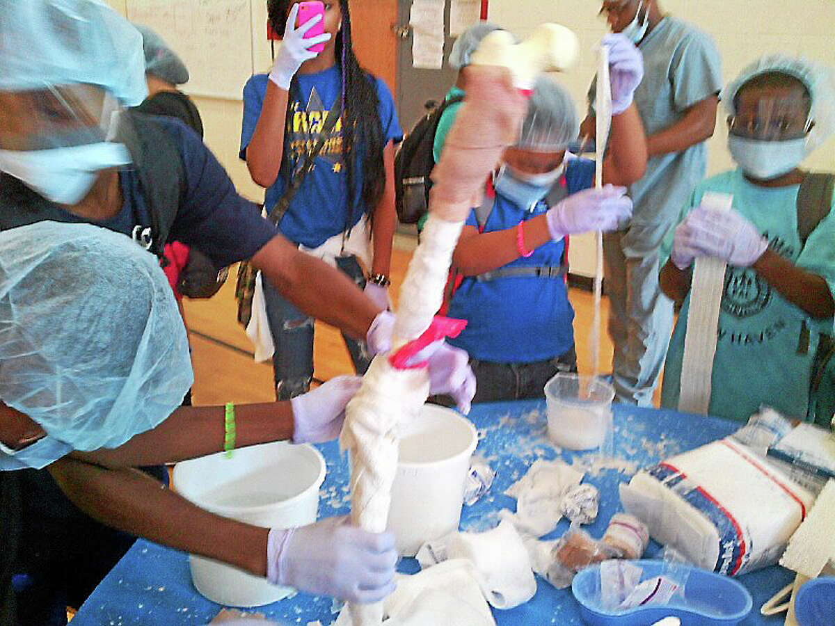 PAL-Camp New Haven campers learn how a bone cast is made.