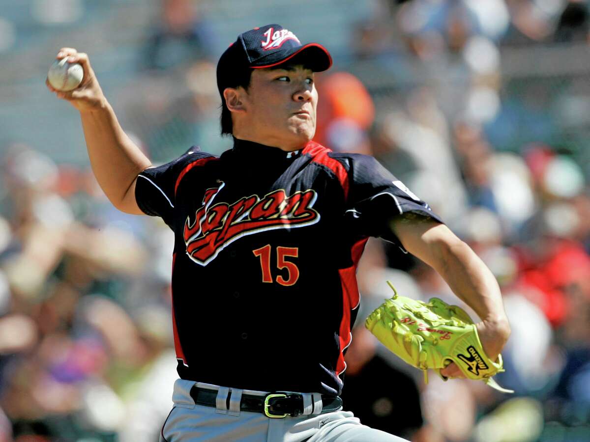 In this March 11, 2009, file photo, Japan’s Masahiro Tanaka pitches to the San Francisco Giants during an exhibition game in Scottsdale, Ariz. The New York Yankees and Tanaka agreed on Wednesday to a $155 million, seven-year contract. In addition to the deal with the pitcher, the Yankees must pay a $20 million fee to the Japanese team of the 25-year-old right-hander, the Rakuten Golden Eagles.