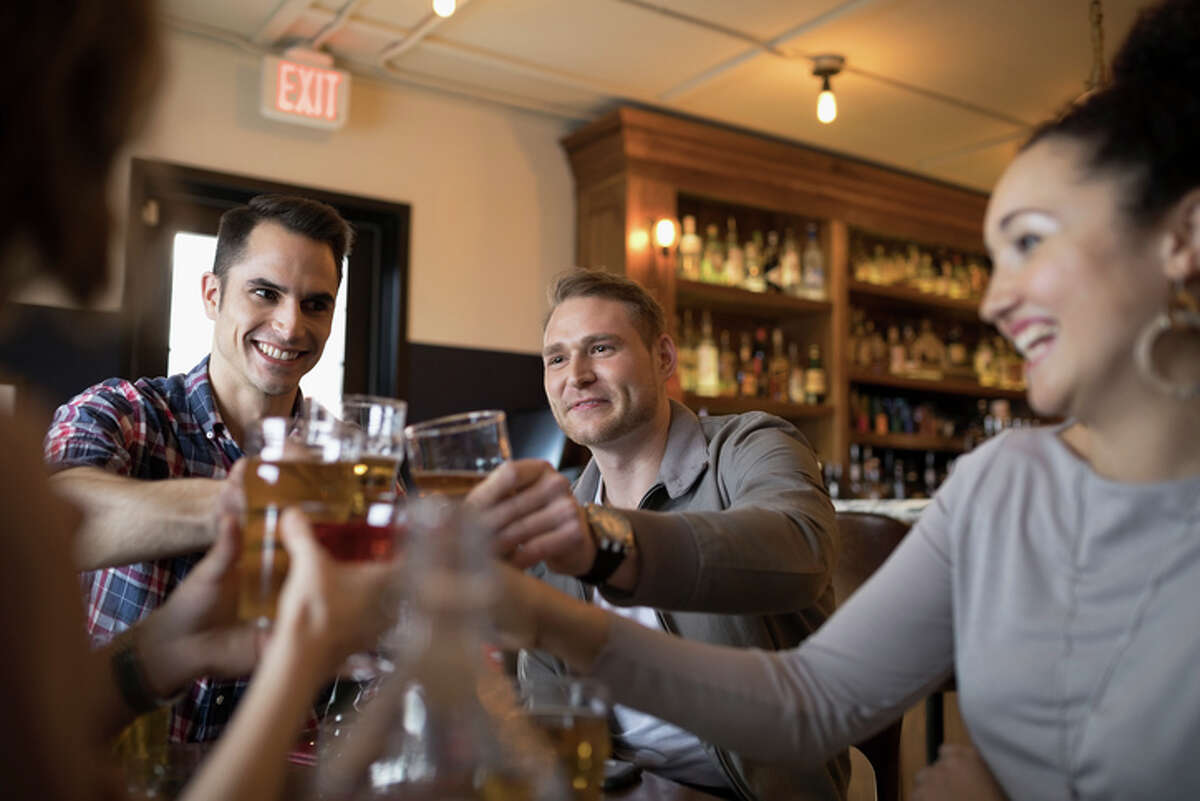 Millennials drinking beer in a bar